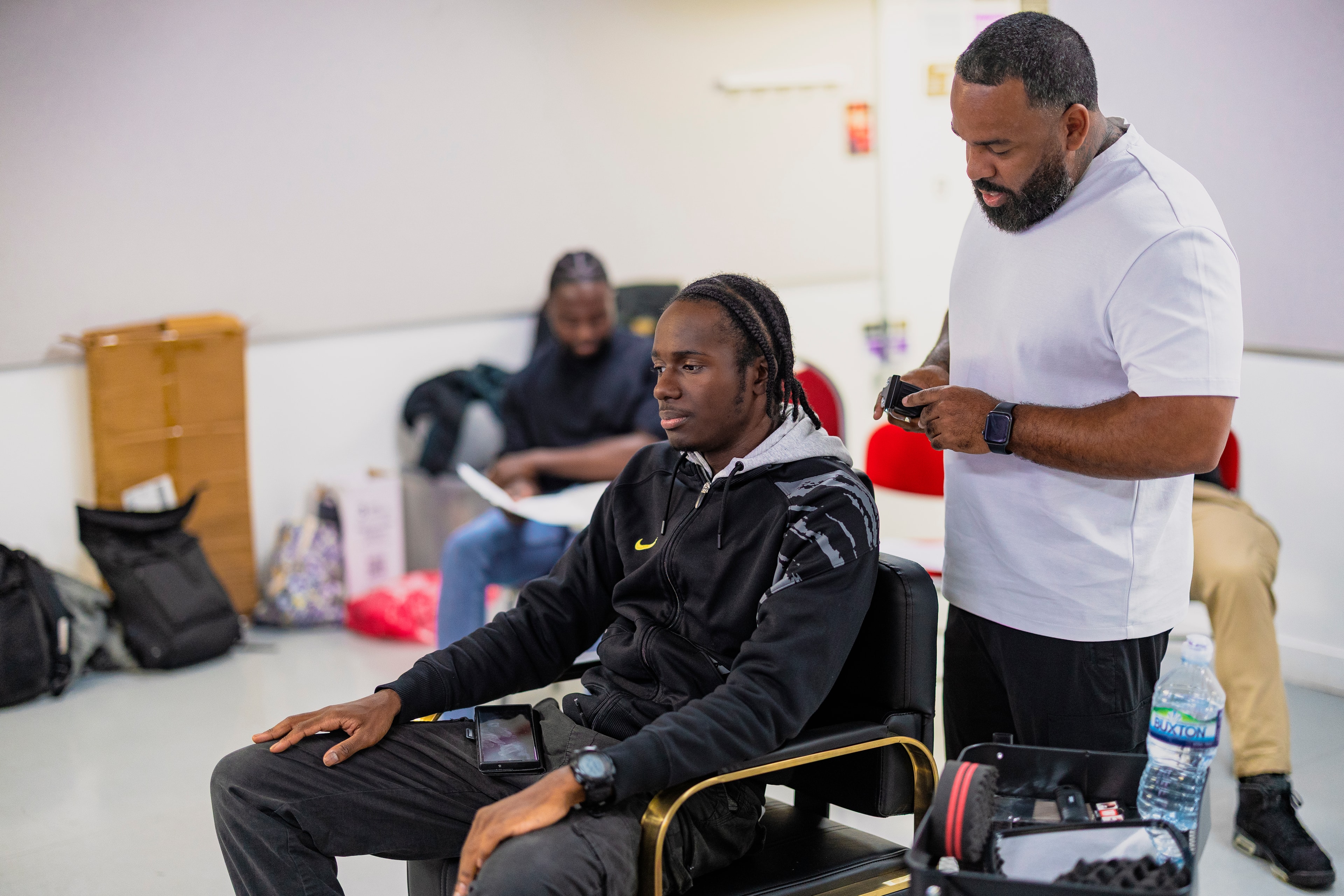 Director working with cast member in the barbershop chair
